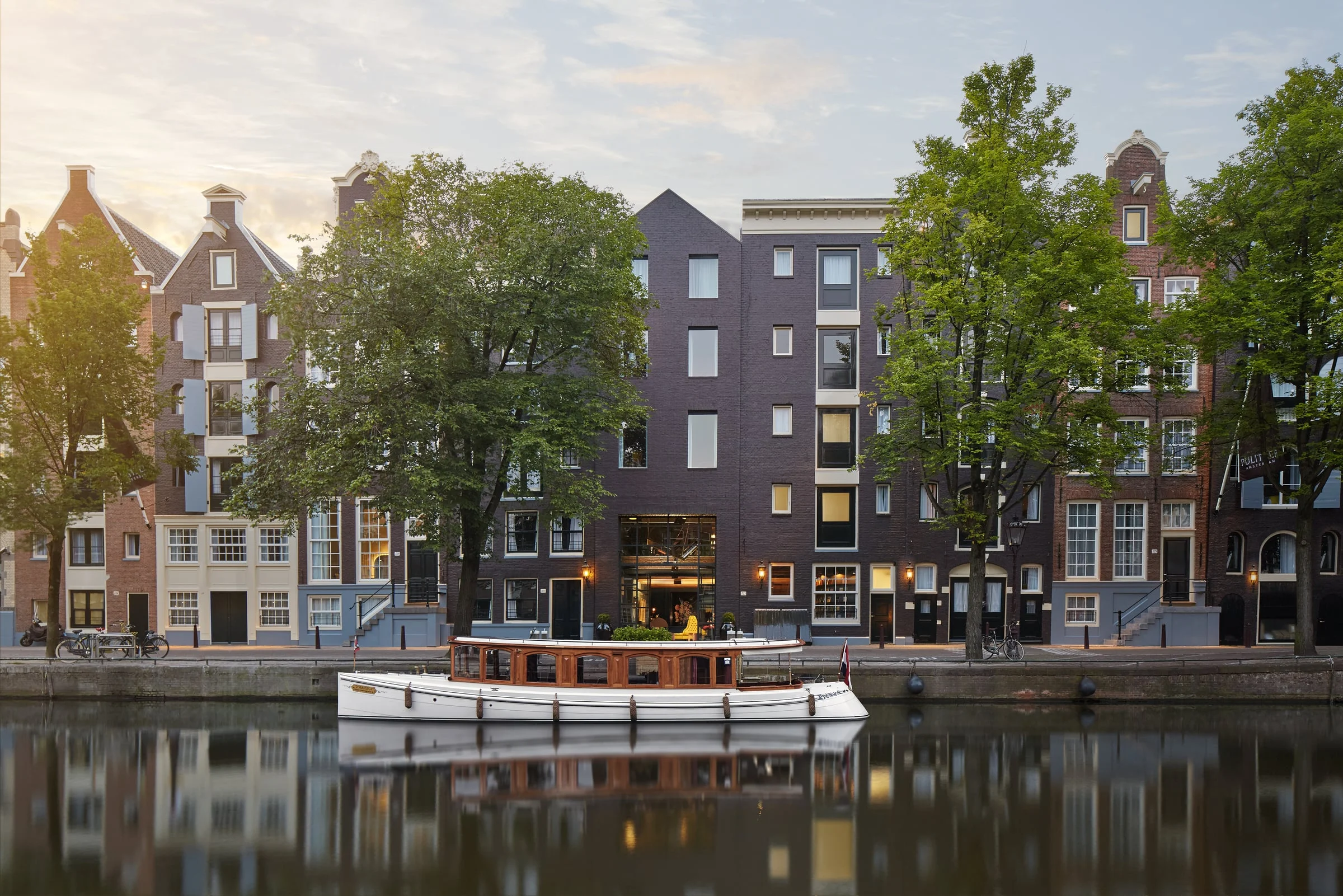Canal houses standing shoulder to shoulder above the water