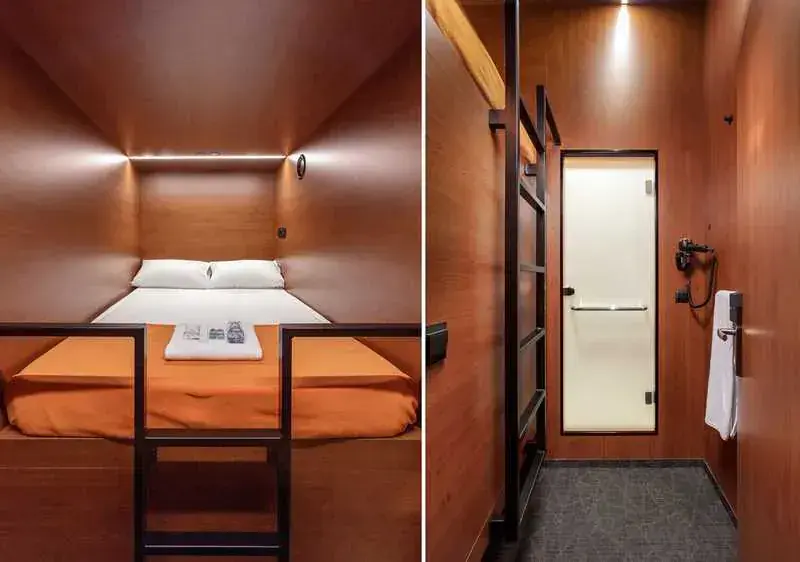 Row of compact sleeping berths along a lit corridor