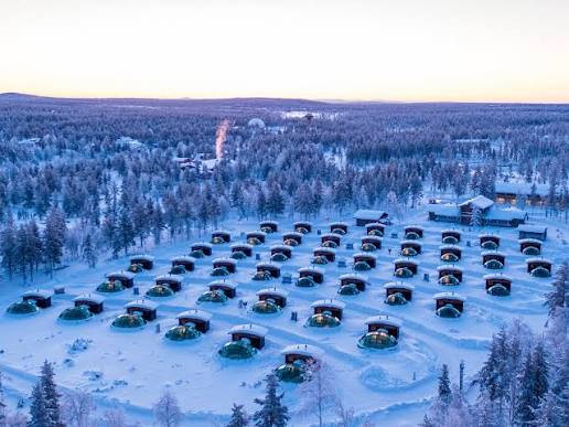 Rounded snow igloos standing on open ground